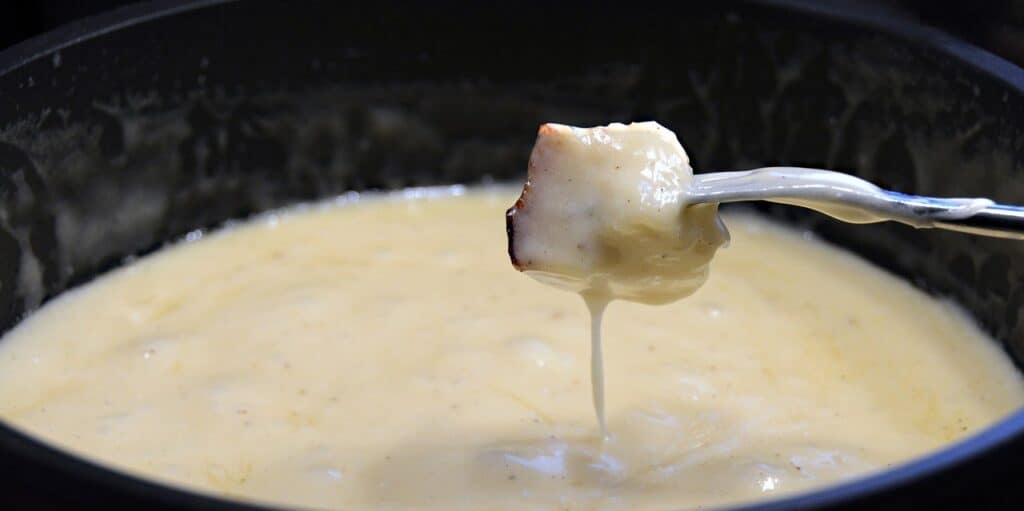 Morceau de pain dans la fondue au fromage