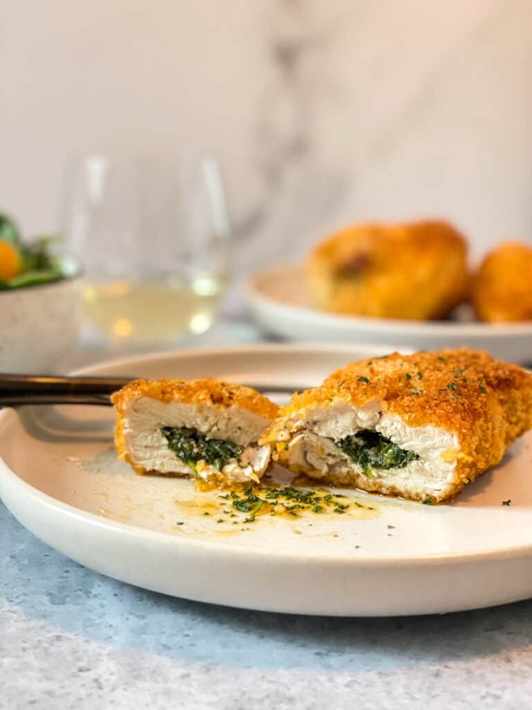 Kiev turkey breast cut in two, with its buttery sauce.